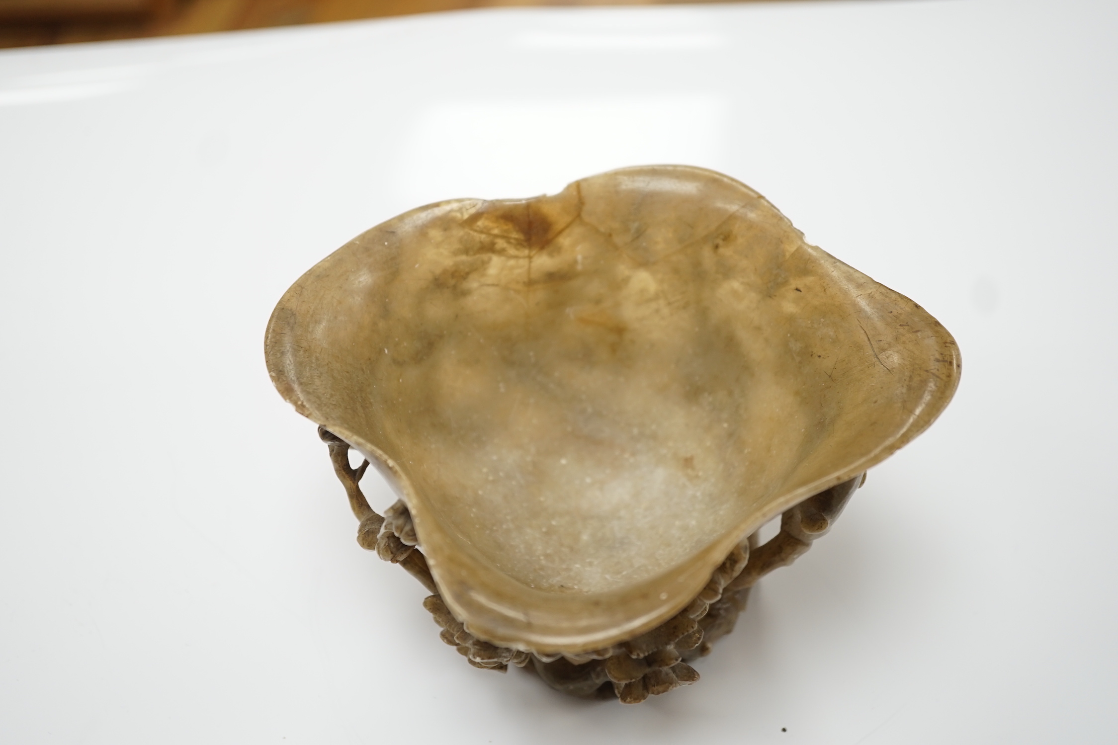 A Chinese carved soapstone libation cup, late 19th century and an elm cased inkstone